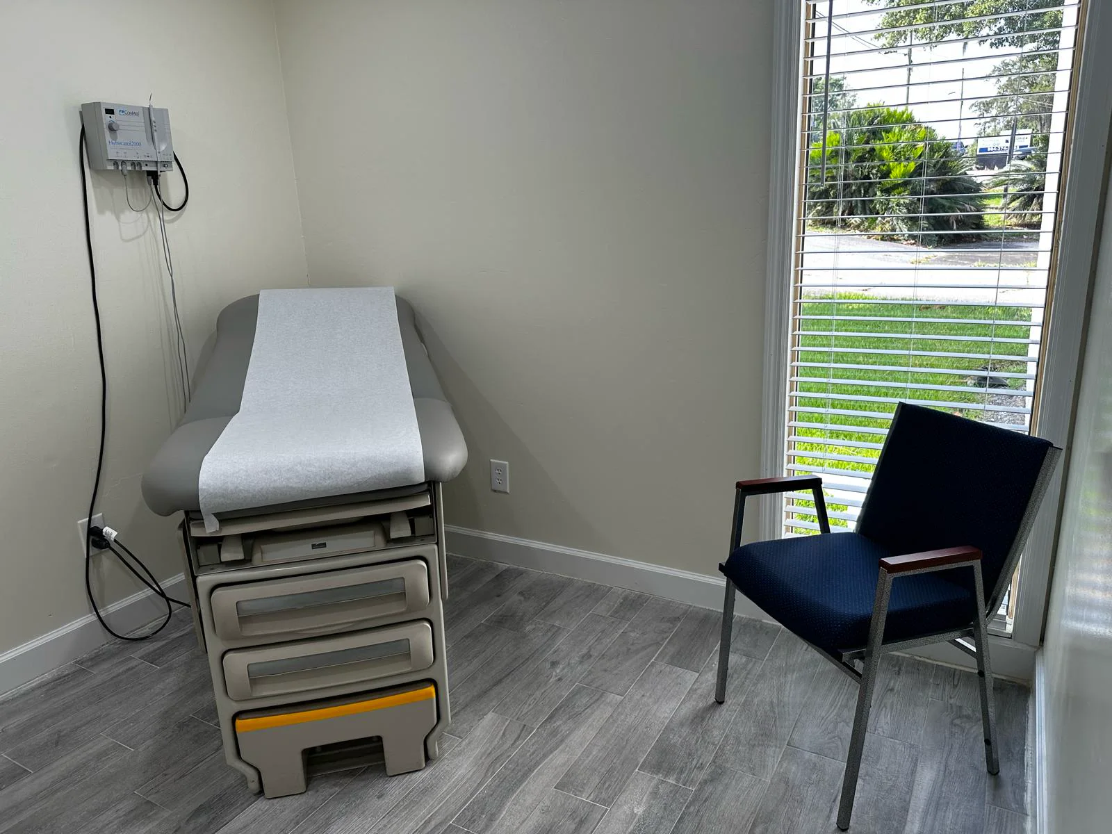 Private treatment room with an exam table and window